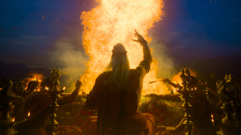 A group of characters sitting around a campfire during some sort of ritual in Varanasi