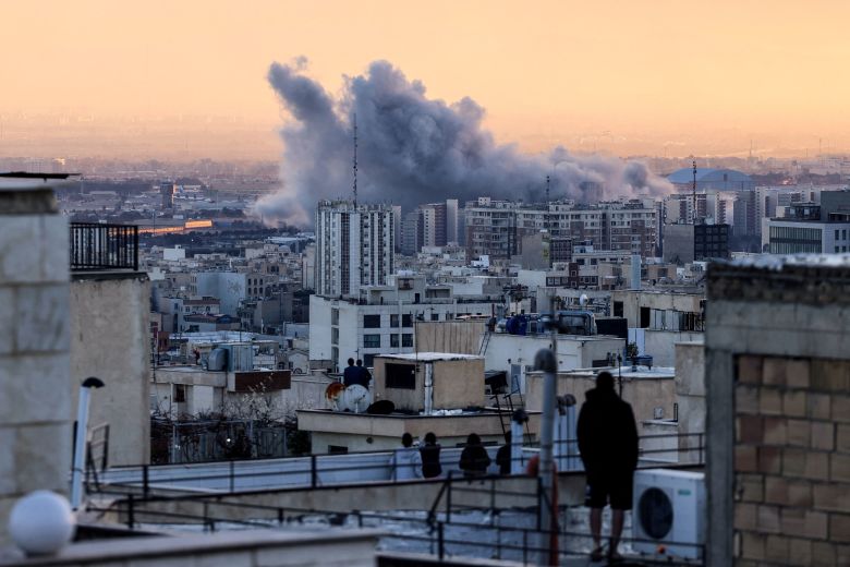 A person stands on the roof after a strike on Tehran, Iran, on March 3, 2026.