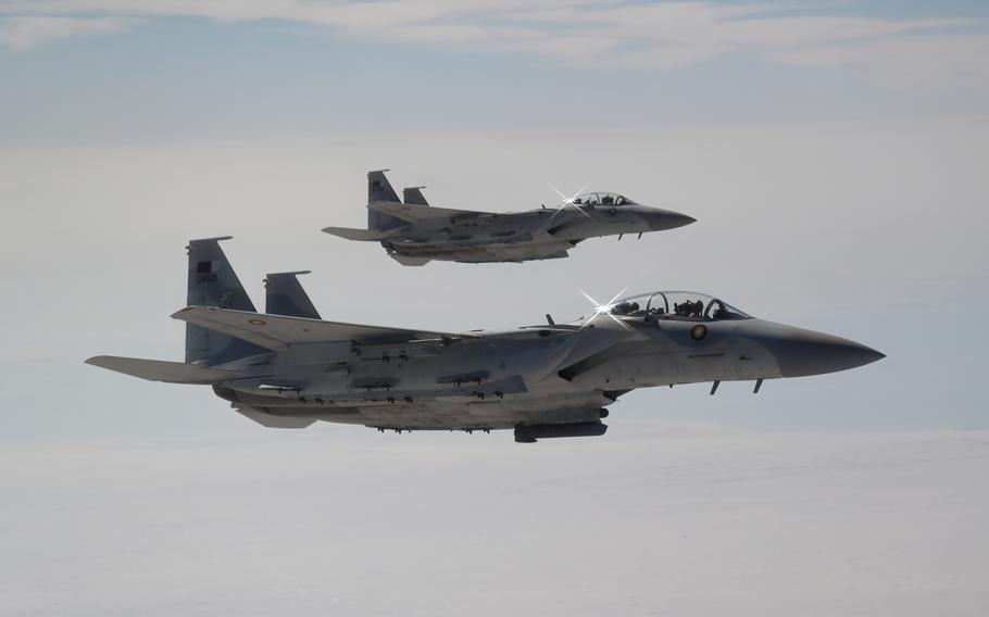 Two aircraft fly side by side.