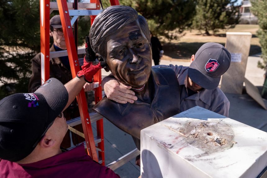 Facilities workers with Denver Arts and Venues remove a bust of United Farm Workers union cofounder Cesar Chavez at Cesar Chavez Park in Denver on Thursday.