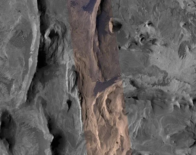 Another view of the geological context, showing nearby features of similar height. This image was taken by the Mars Reconnaissance Orbiter's HiRISE camera, which acquires colour infrared information along a central strip. (<span><a href="https://hirise.lpl.arizona.edu/PSP_002841_1740" rel="nofollow noopener" target="_blank" data-ylk="slk:NASA/JPL-Caltech/UArizona;elm:context_link;itc:0;sec:content-canvas" data-yga="{"yLinkElement":"context_link","yModuleName":"content-canvas","yLinkText":"NASA/JPL-Caltech/UArizona"}" class="link ">NASA/JPL-Caltech/UArizona</a>)</span>