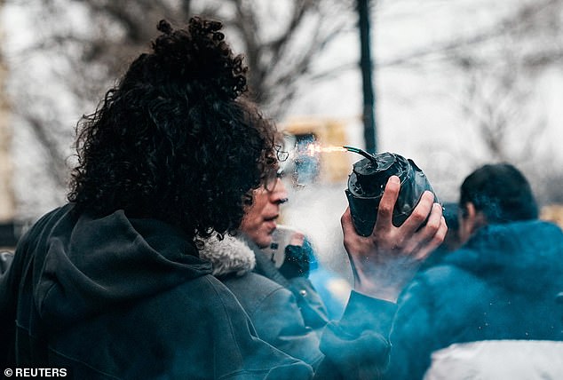 Emir Balat, 18, is pictured allegedly lighting and dropping an explosive at a counter-protest against an anti-Muslim demonstration organized by far-right influencer Jake Lang
