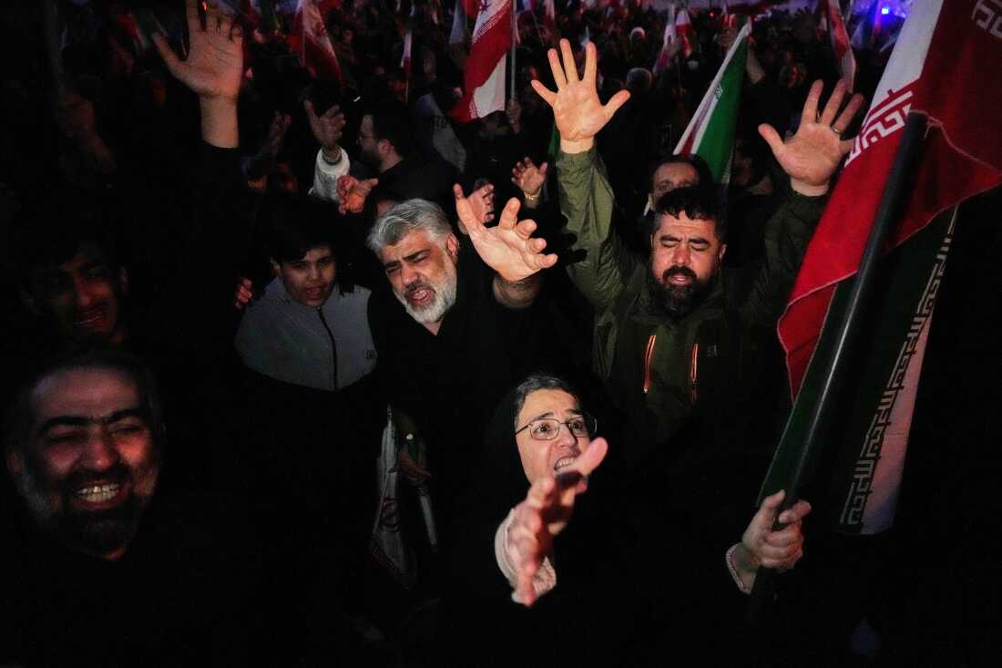 Government supporters chant slogans as they gather in mourning after state TV officially announced the death of Iranian Supreme Leader Ayatollah Ali Khamenei, in Tehran, Iran, Sunday, March 1, 2026