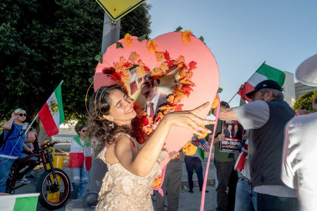 Demonstrators in support of a war in Iran at City Hall in Los Angeles, California, US, on Saturday, Feb. 28, 2026. Iran's supreme leader was killed in US-Israeli airstrikes, raising the stakes in a conflict that's spiraling across the oil-rich Middle East and disrupting traffic around the Hormuz shipping strait.