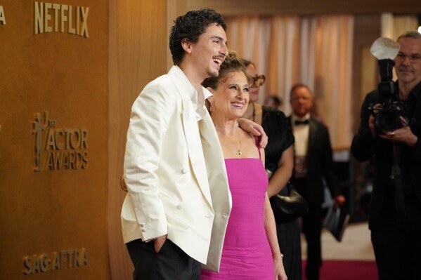 Timothee Chalamet, left, and Nicole Flender arrive at the 32nd Annual Actor Awards on Sunday, March 1, 2026, at the Shrine Auditorium and Expo Hall in Los Angeles. (Photo by Jordan Strauss/Invision/AP)