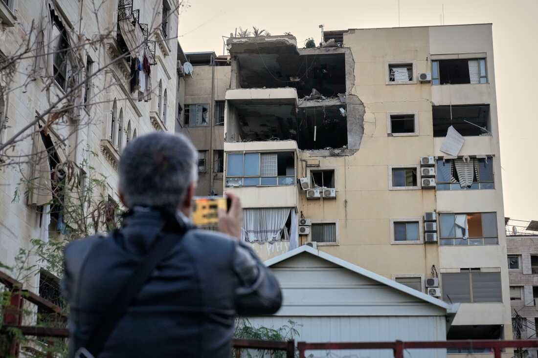 A man takes pictures of the damage in an apartment building after it was hit by an Israeli airstrike in Dahiyeh, Beirut's southern suburb, Lebanon, Monday, March 2, 2026.
