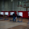 A voter carries a ballot during early voting for New York City's mayoral election on Oct. 25, 2025.