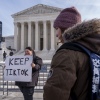 A woman holds a sign that reads "Keep TikTok" outside the Supreme Court.