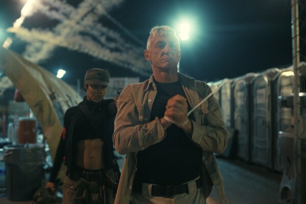 This image released by Warner Bros. Pictures shows Teyana Taylor, left, and Sean Penn in a scene from "One Battle After Another." (Warner Bros. Pictures via AP)