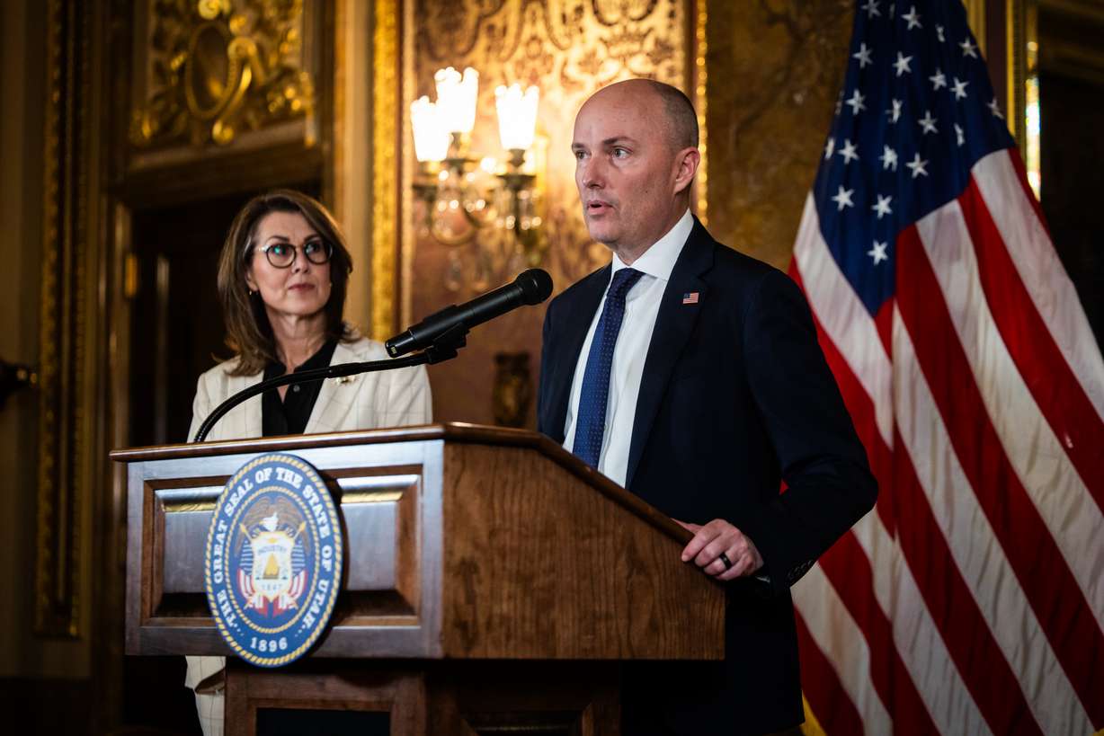 Lt. Gov. Deidre Henderson, left, listens as Gov. Spencer Cox speaks during a press conference on the last day of the legislative session in the Capitol's Gold Room in Salt Lake City on Friday.