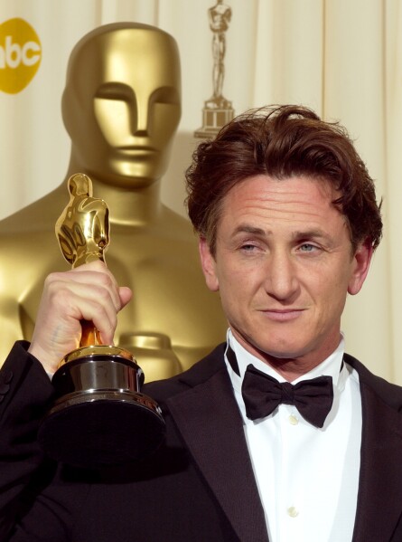 FILE - Sean Penn holds the Oscar he won for best actor for his work in "Mystic River" at the 76th annual Academy Awards Feb. 29, 2004, in Los Angeles. (AP Photo/Reed Saxon)
