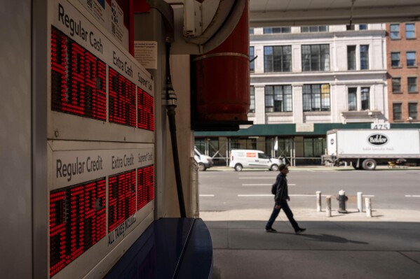 A person walks past a gas station March 10, 2026, in New York. (AP Photo/Yuki Iwamura, File)