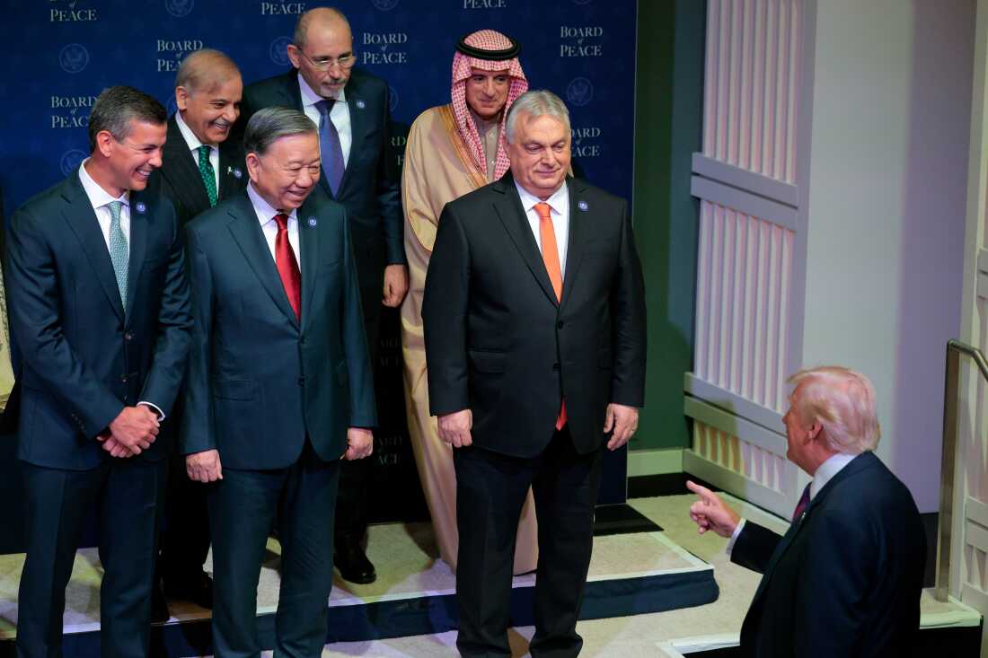 World leaders including Hungary's Prime Minister Viktor Orbán (center) watch as President Trump arrives for the inaugural meeting of the Board of Peace at the Donald J. Trump Institute of Peace on Feb. 19 in Washington, D.C.