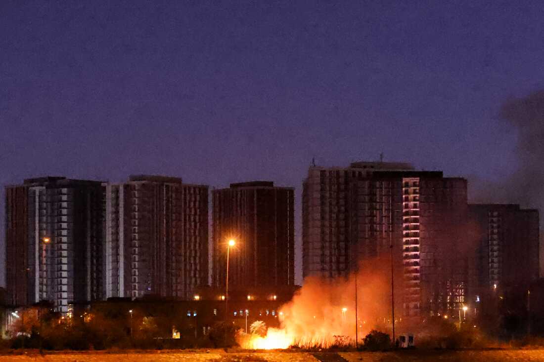 A fire burns outside the grounds of the U.S. Embassy headquarters in Baghdad's fortified "Green Zone" on Tuesday, following a drone and rocket attack, according to security officials. The strikes came hours after air defenses thwarted a rocket attack at the embassy and a drone sparked a fire at a luxury hotel frequented by foreign diplomats in the Green Zone.