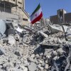 An Iranian flag is planted in the rubble of a police station, damaged in airstrikes on March 3, 2026 in Tehran, Iran.