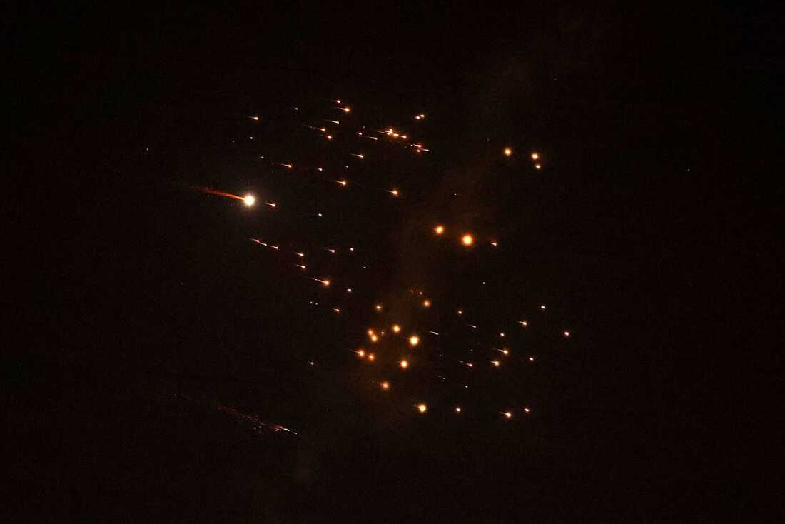 Rocket trails are seen in the sky amid a fresh barrage of Iranian missile attacks above the Israeli coastal city of Netanya on March 18, 2026.