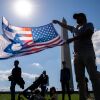 An attendee holds a U.S. and Israeli flag at an October 7th memorial rally near the Washington Monument in Washington, D.C. on Oct. 7, 2024.