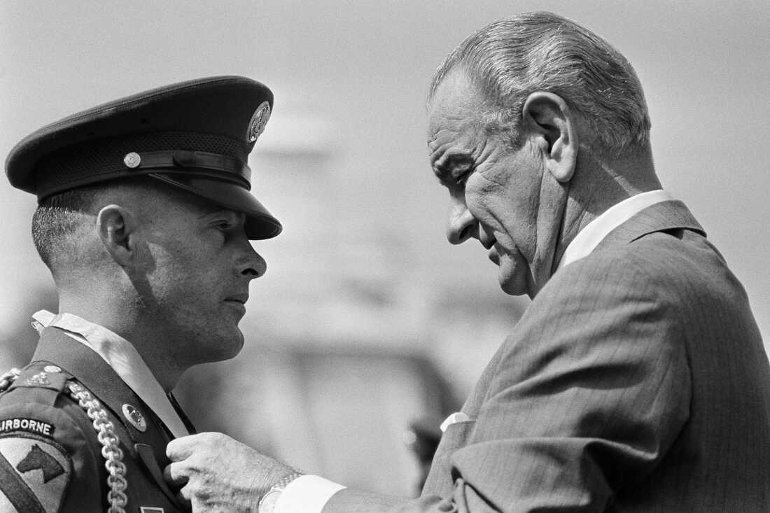 President Lyndon Johnson awards the Medal of Honor to Army Staff Sgt. Delbert O. Jennings of Stockton, Calif., for heroism in Vietnam on the White House grounds on Sept. 19, 1968.