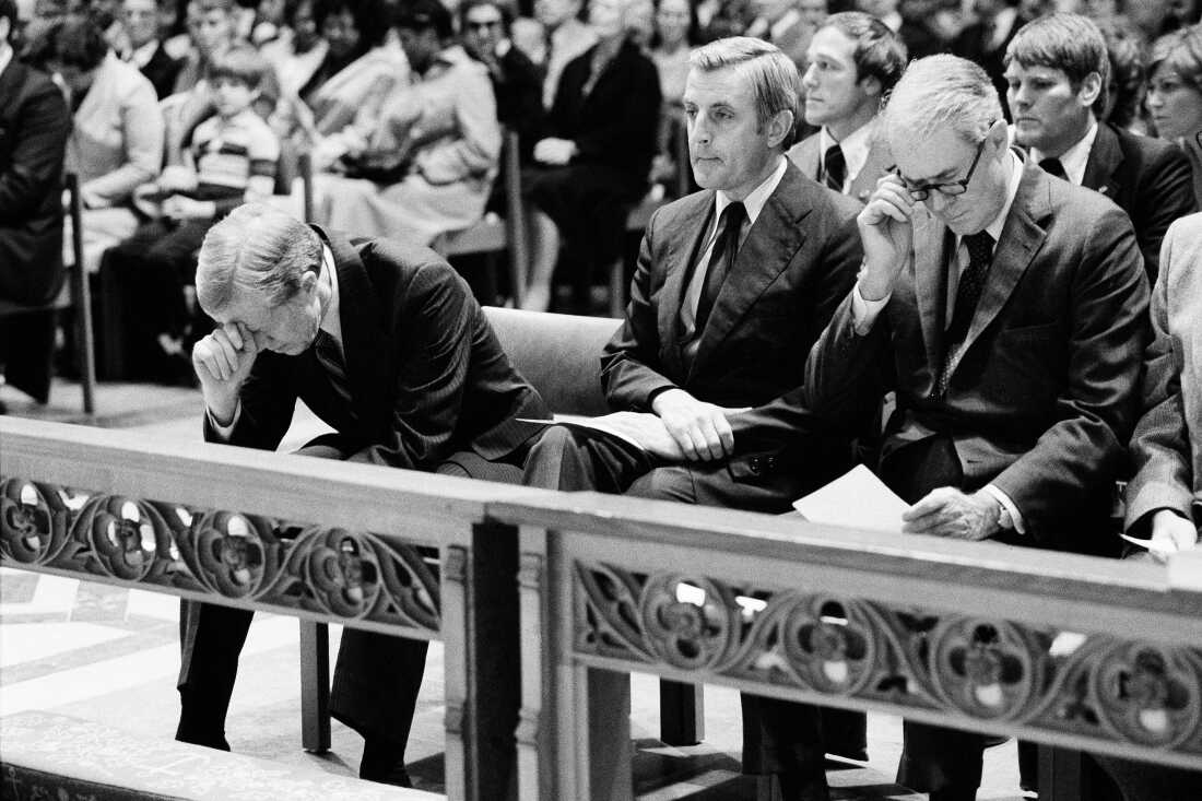 President Jimmy Carter (left) bows his head during a prayer service at Washington Cathedral on Nov. 15, 1979, for the hostages being held at the U.S. Embassy in Tehran, Iran. Vice President Walter F. Mondale (center) and Secretary of State Cyrus Vance are to his left.