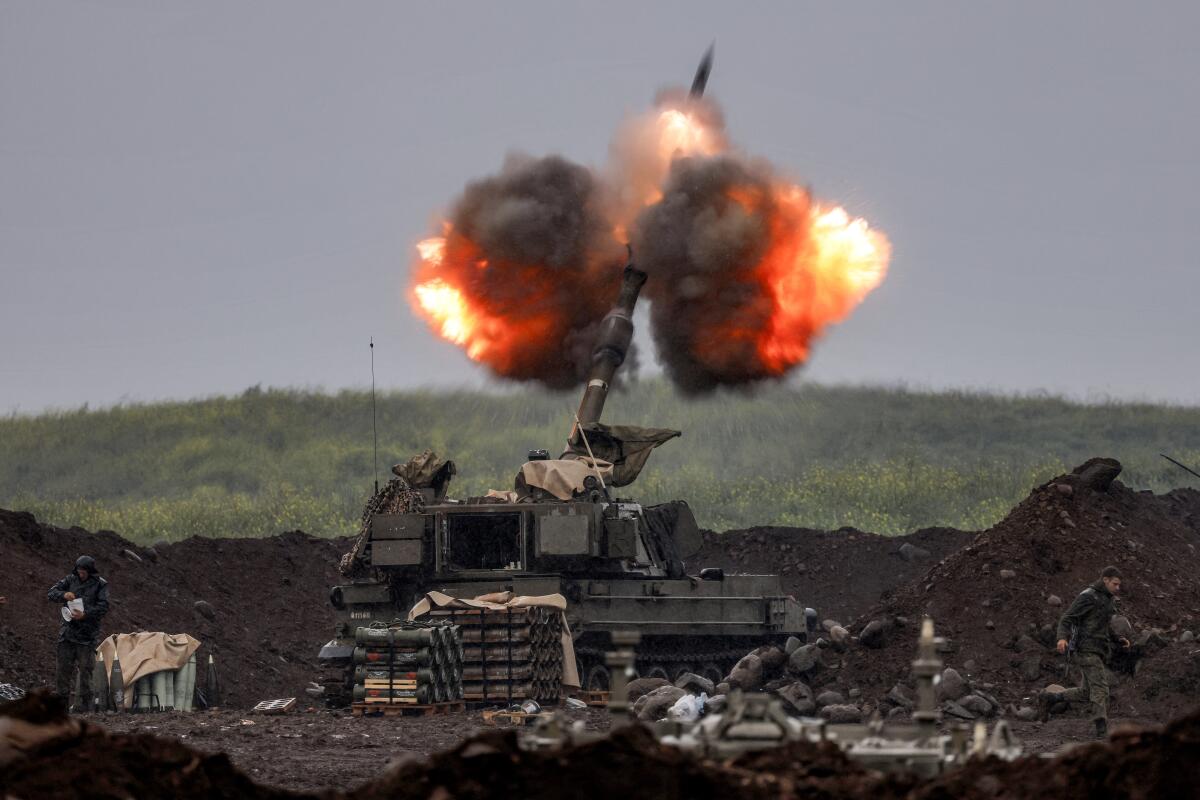 An Israeli self-propelled howitzer artillery gun fires rounds