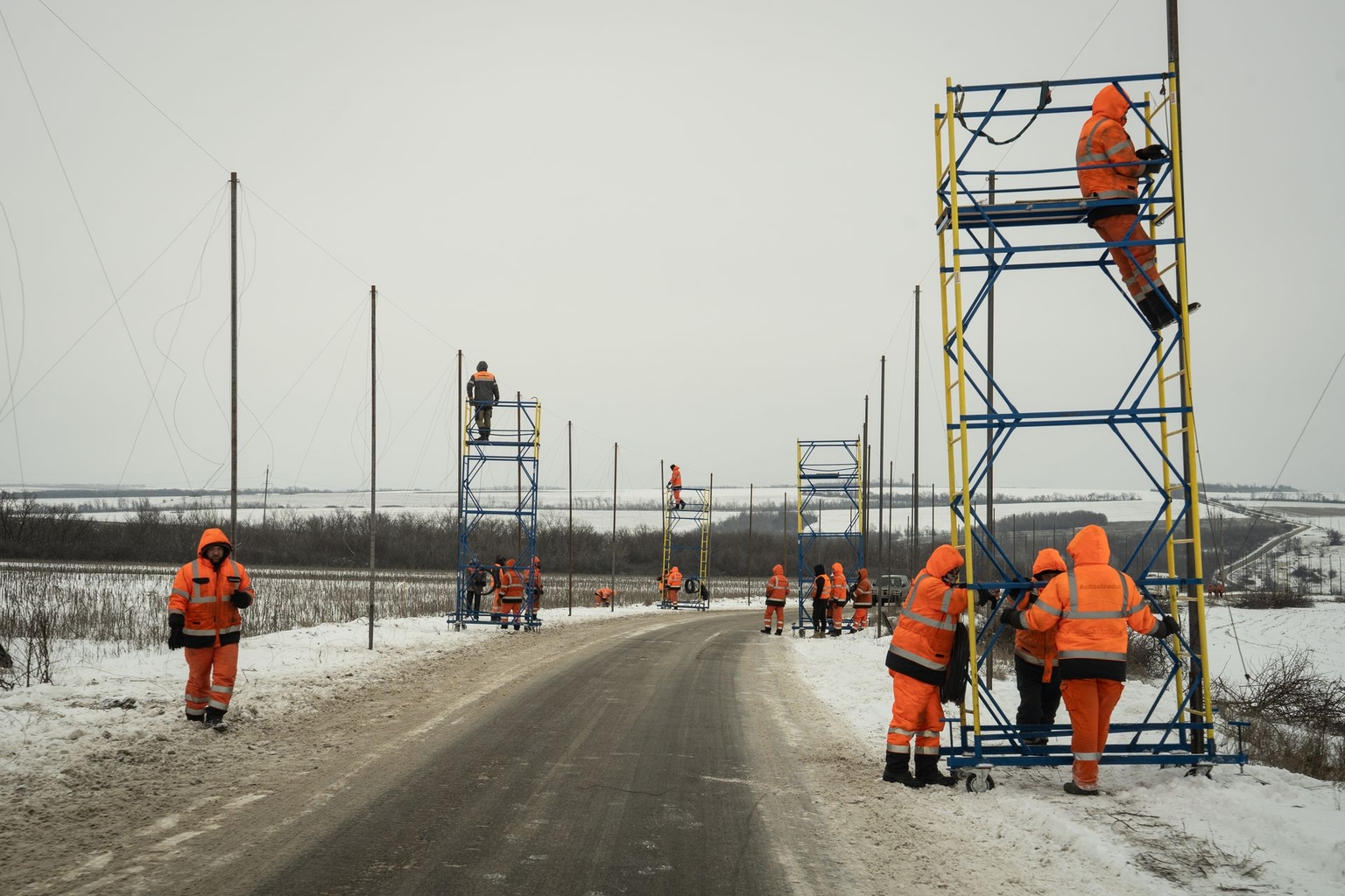 Workers install anti-drone nets above a road in eastern Ukraine to help protect vehicles from Russian FPV drone attacks near the front line in Donetsk Oblast on Jan. 25, 2026.