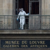 A forensics officer examines the cut window and balcony of a gallery at the Louvre Museum which was the scene of a robbery on October 19 in Paris.