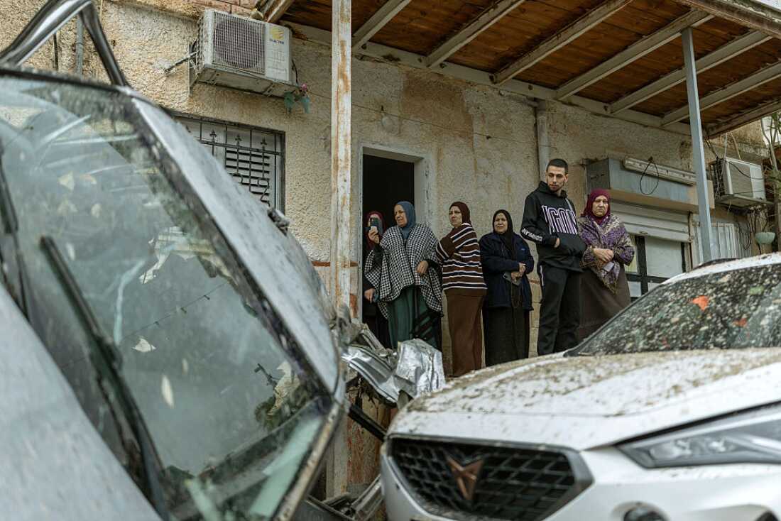 Arab-Israeli residents surveys the damage following a projectile strike in the Arab-Israeli city of Kfar Qassem on March 26, 2026.