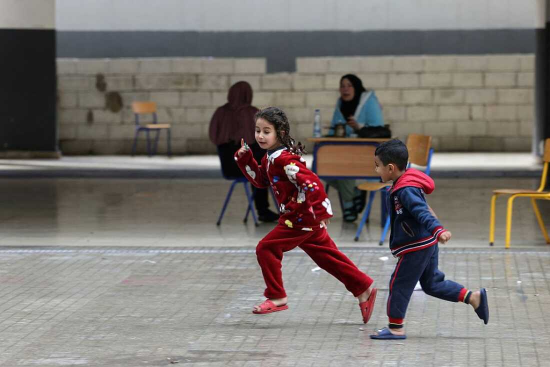 Displaced Lebanese children play in the playground of a public school that has been converted into a shelter in the town of Dekwaneh, north of Beirut on March 25, 2026.