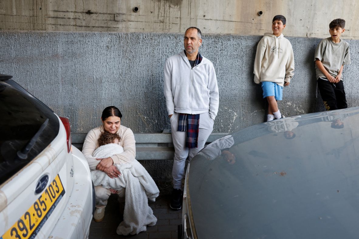 People take shelter under a highway bridge near Latrun, Israel, on February 28.