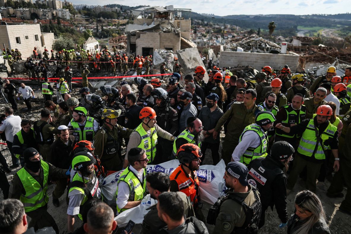 Emergency personnel carry a body at the site of a strike in Beit Shemesh, Israel, on March 1.