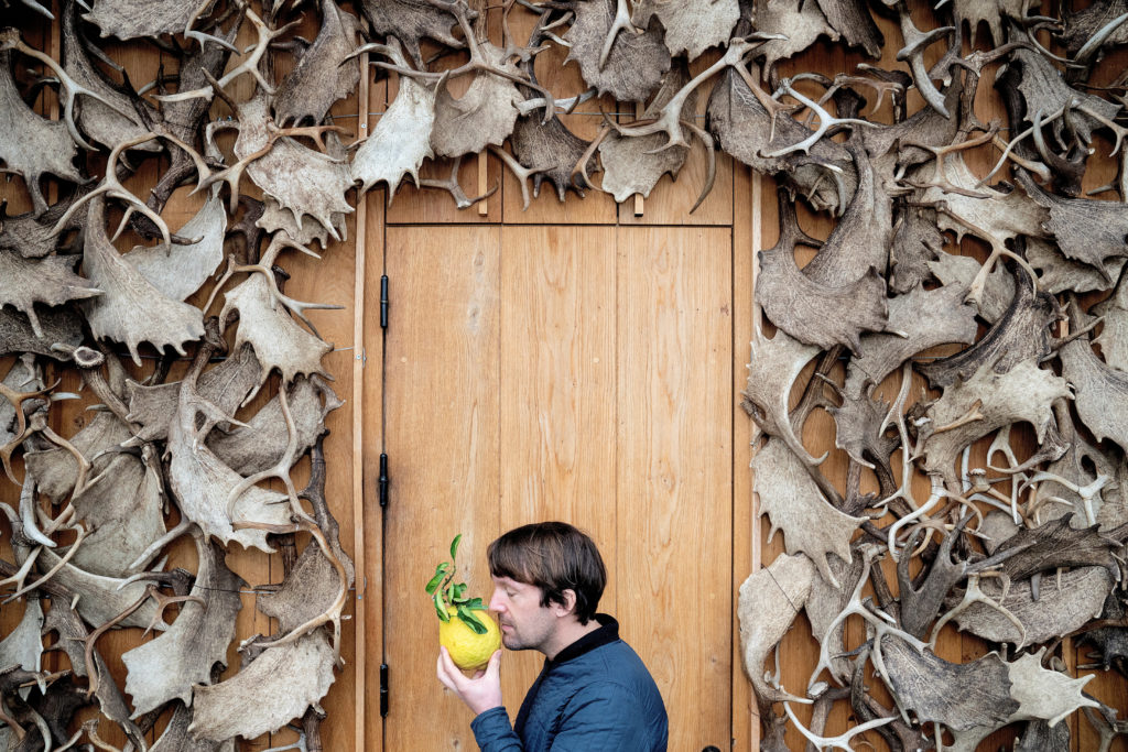 FILE PHOTO: Noma's Redzepi with a citrus fruit in Copenhagen