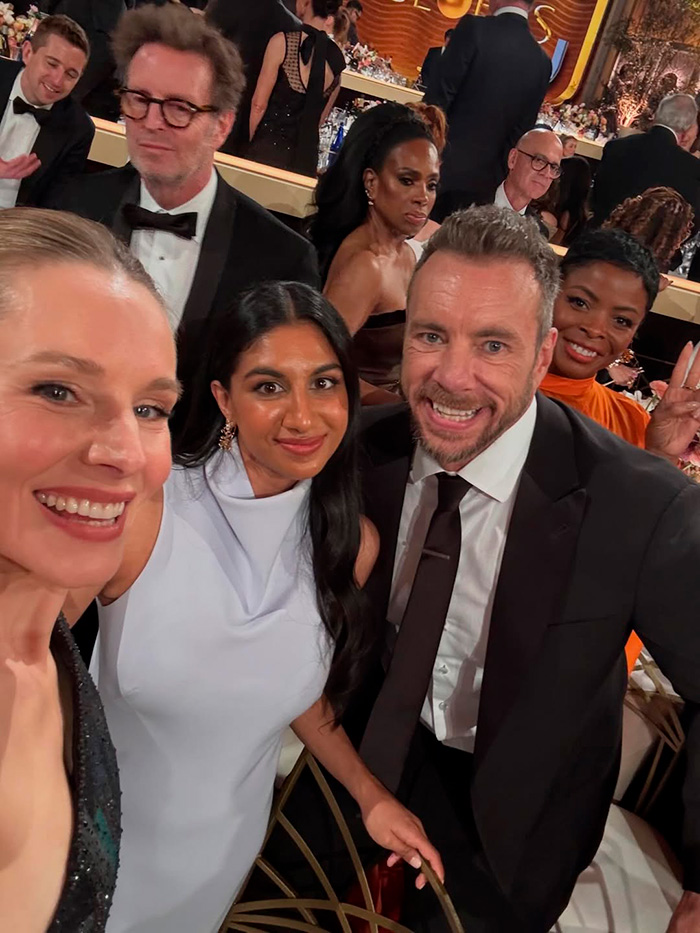 Kristen Bell and Dax Shepard smiling at an event, highlighting their three-way marriage and reported constant fights.