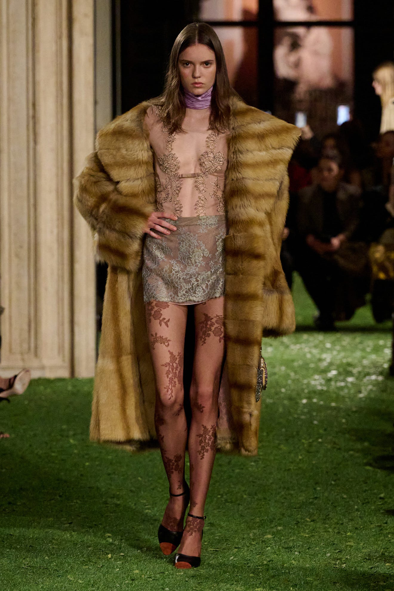 model on a runway showcasing a fashionable outfit