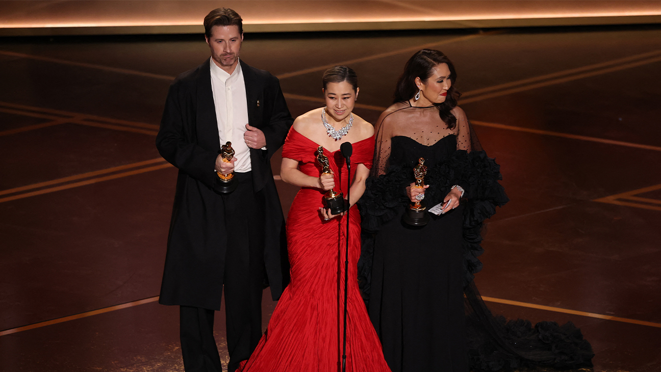US director Chris Appelhans, South Korean-Canadian storyboard artist and writer Maggie Kang and producer Michelle Wong speak onstage after accepting the Oscar for Best Animated Feature Film "KPop Demon Hunters" during the 98th Annual Academy Awards at the Dolby Theatre in Hollywood, California on March 15, 2026.