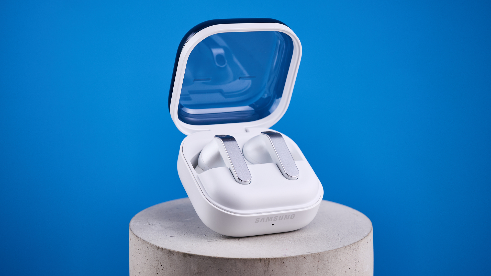 the samsung galaxy buds 4 pro in white photographed against the blue tom's guide background