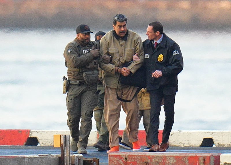 Nicolas Maduro is seen in handcuffs after landing at a Manhattan helipad, escorted by heavily armed Federal agents as they make their way into an armored car en route to a Federal courthouse in Manhattan on January 5, 2026 in New York City.
