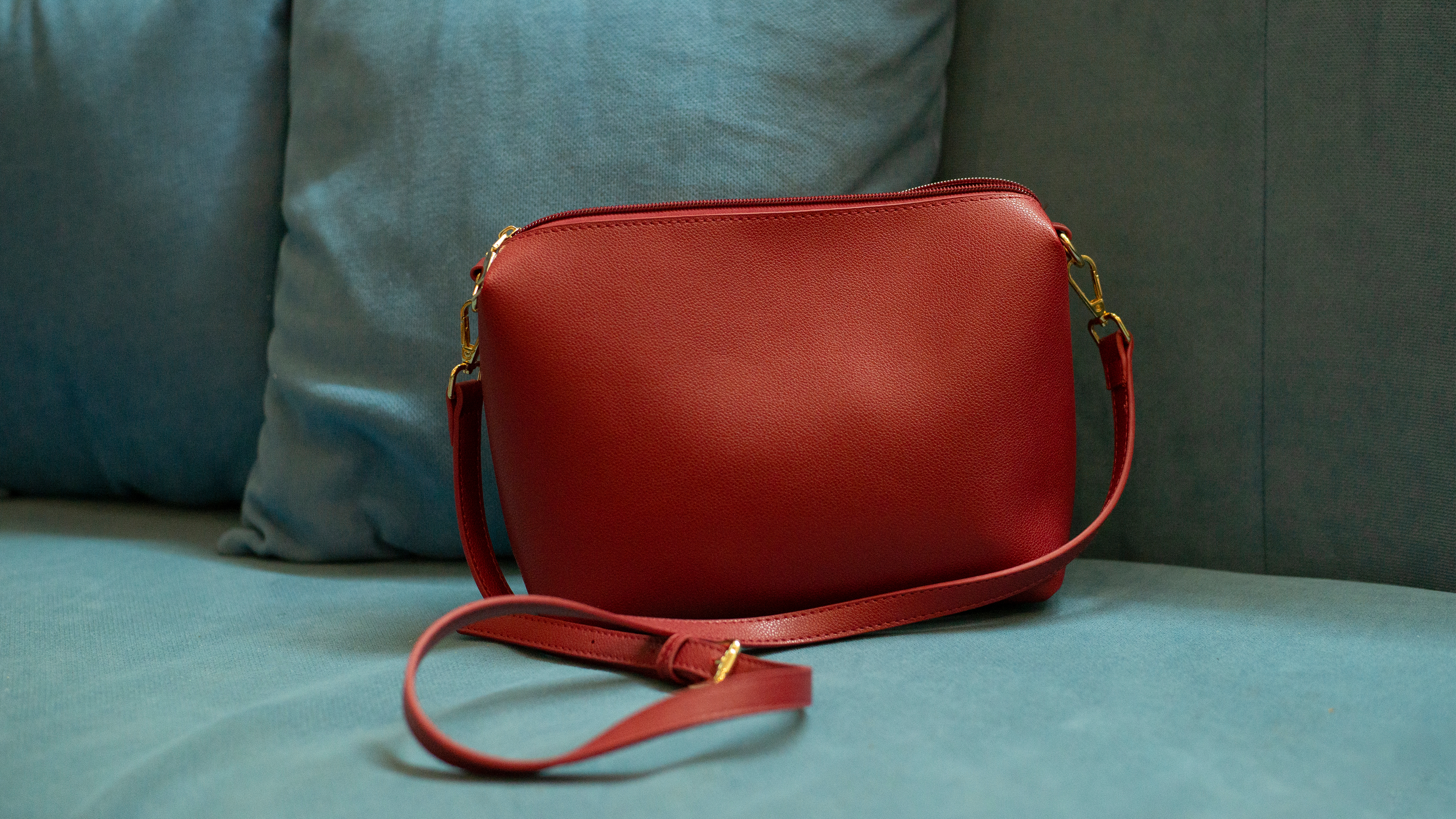 Red handbag on grey sofa