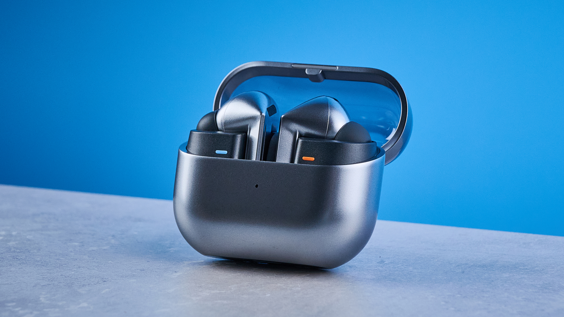 the samsung galaxy buds 3 pro photographed against the blue tom's guide background