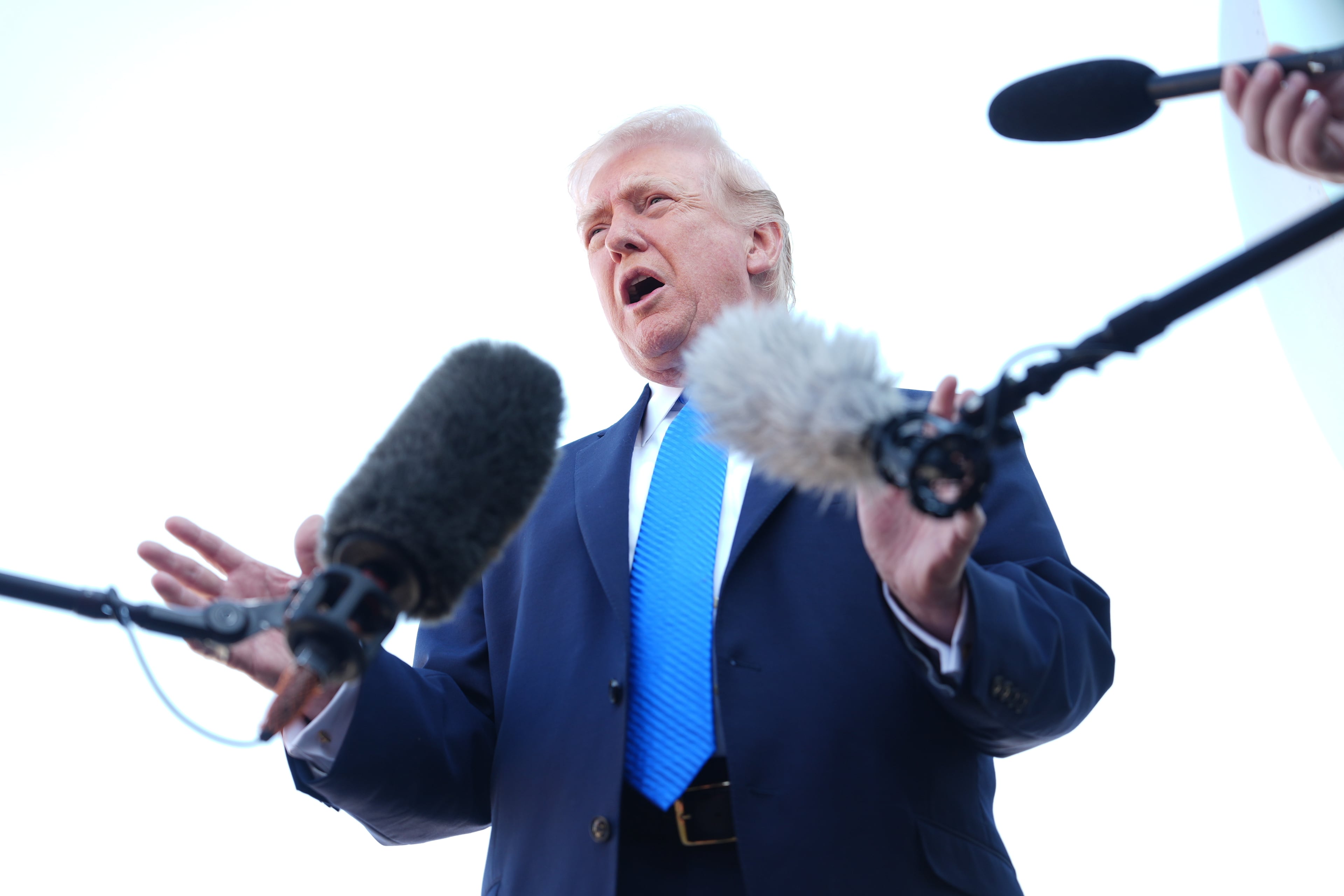 President Donald Trump speaks with the media before boarding Air Force One on Monday. (Mark Schiefelbein/AP)