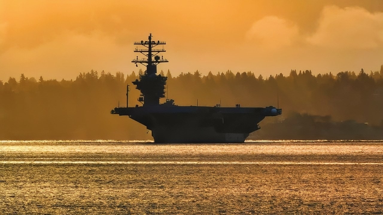 MANCHESTER, Wash. (April 28, 2017) USS Nimitz (CVN 68) transits Puget Sound, past the Seattle skyline enroute to its homeport, Naval Base Kitsap-Bremerton. The return to homeport marks the end of an underway along with its Carrier Strike Group 11, having successfully completed its final pre-deployment assessment, Composite Training Unit Exercise, April 21, and is now fully certified to deploy later this year. (U.S. Navy photo by Mass Communication Specialist 2nd Class Vaughan Dill/Released