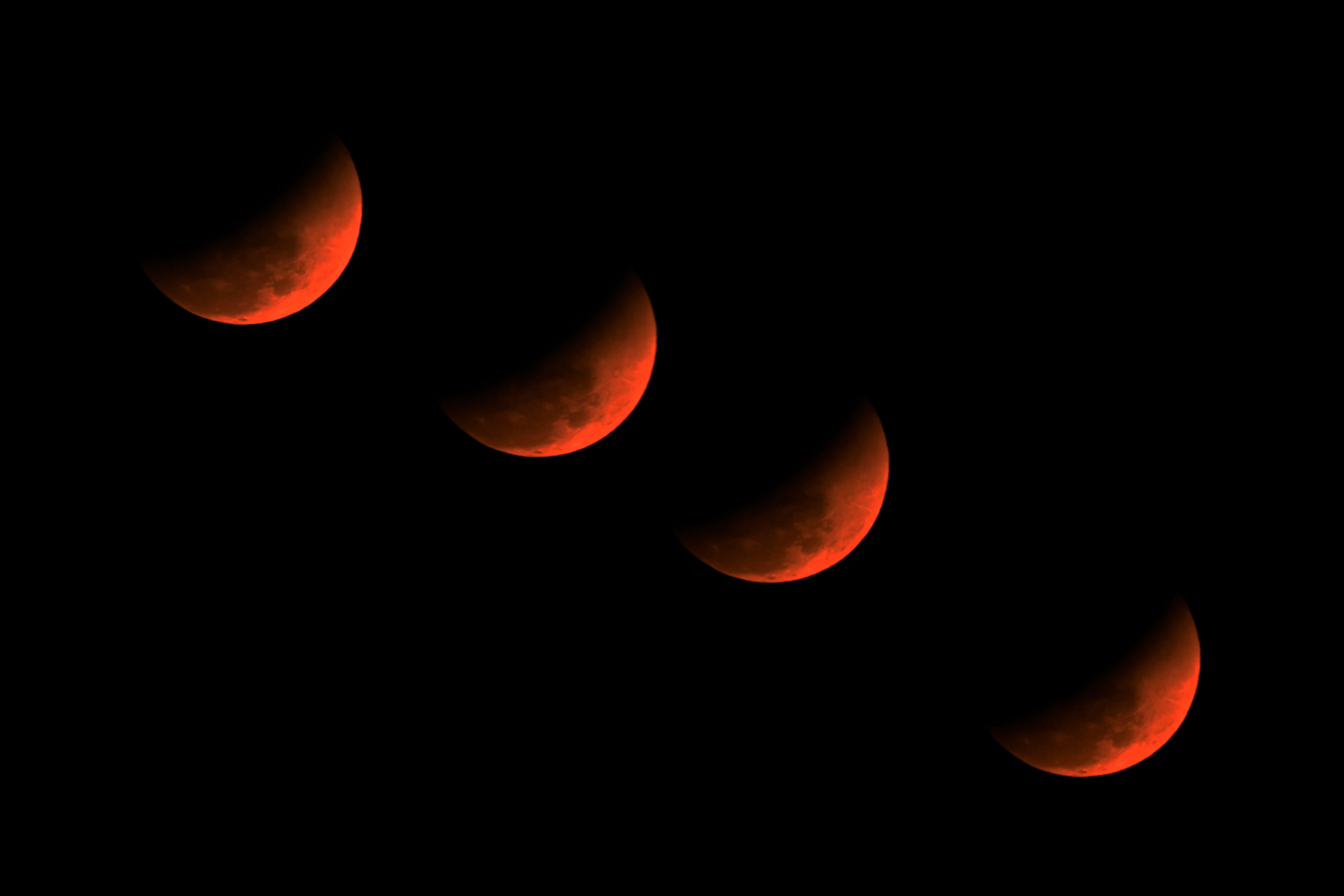 A multiple exposure picture of the &lsquo;blood moon&rsquo; over Golaghat in Assam, India.