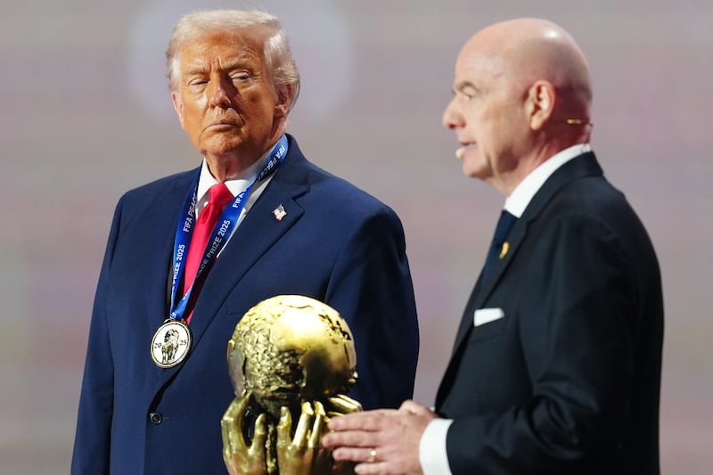 WASHINGTON, DC - DECEMBER 05: U.S. President Donald Trump receives the FIFA Peace Prize from Gianni Infantino, President of FIFA, during the FIFA World Cup 2026 Official Draw at John F. Kennedy Center for the Performing Arts on December 05, 2025 in Washington, DC. (Photo by Jia Haocheng - Pool/Getty Images)