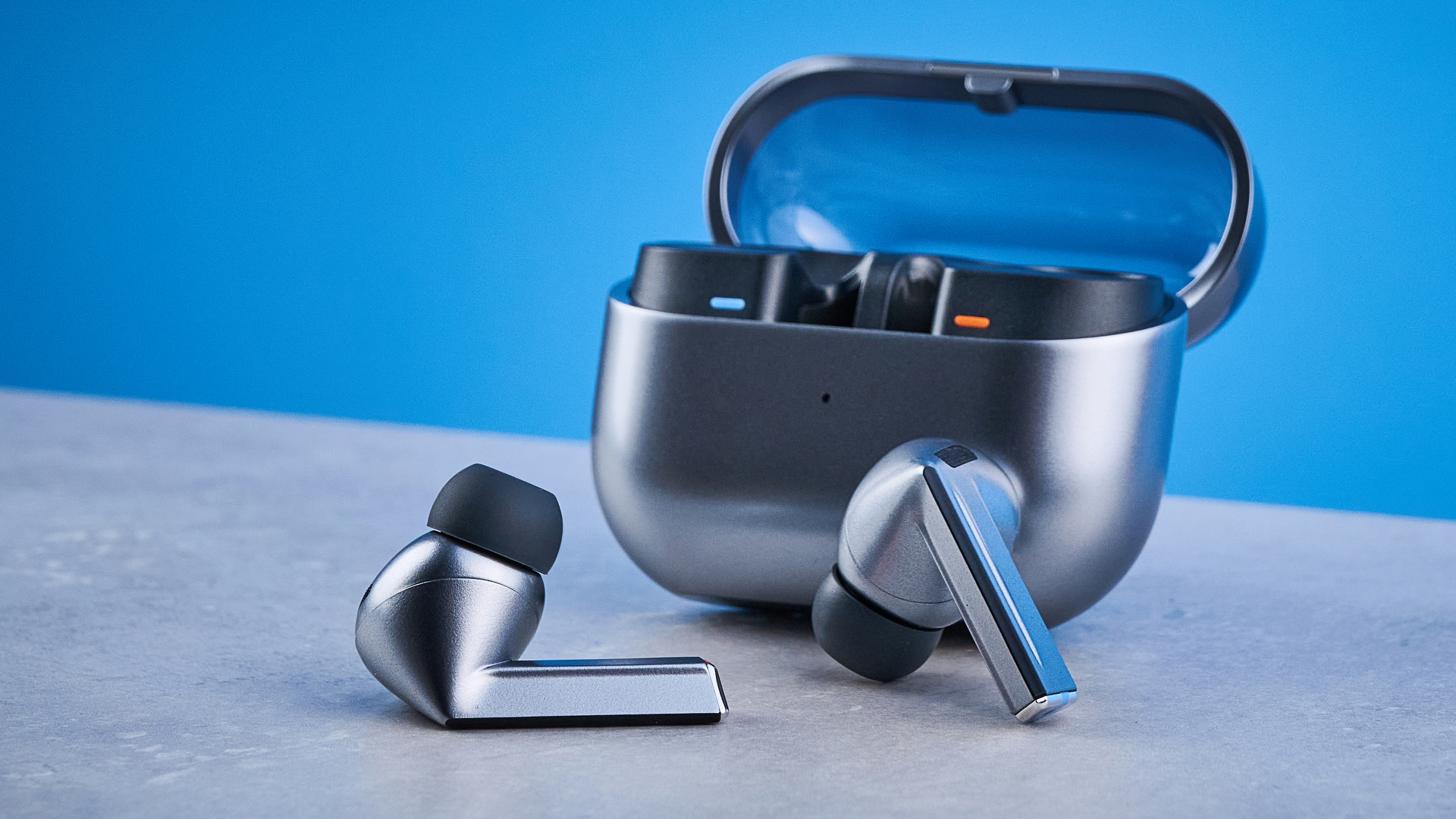 the samsung galaxy buds 3 pro photographed against the blue tom's guide background