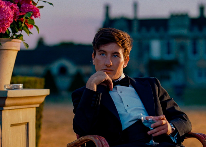 Barry Keoghan dressed in tuxedo, seated outdoors at dusk, reflecting his acting career amid fan backlash.
