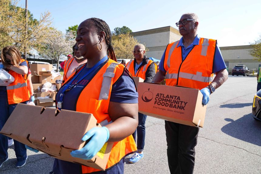 Volunteers with the Atlanta Community Food Bank help distribute food for TSA agents Friday in Atlanta.
