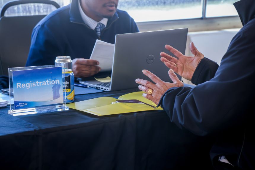 A recruiter speaks with a jobseeker during a job fair in Jersey City, New Jersey, on Tuesday, March 17, 2026.