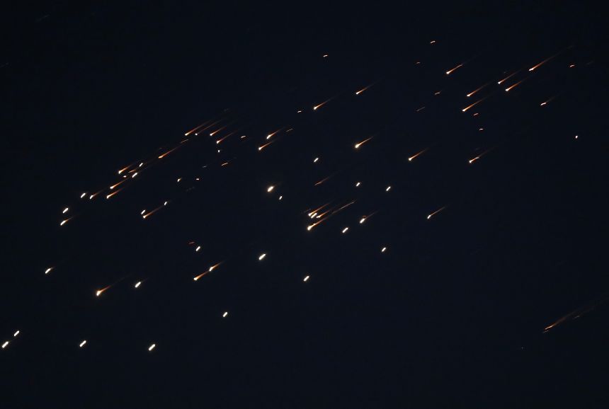Missiles fired from Iran toward Israel are seen in the skies over Hebron, West Bank, on March 18, 2026.