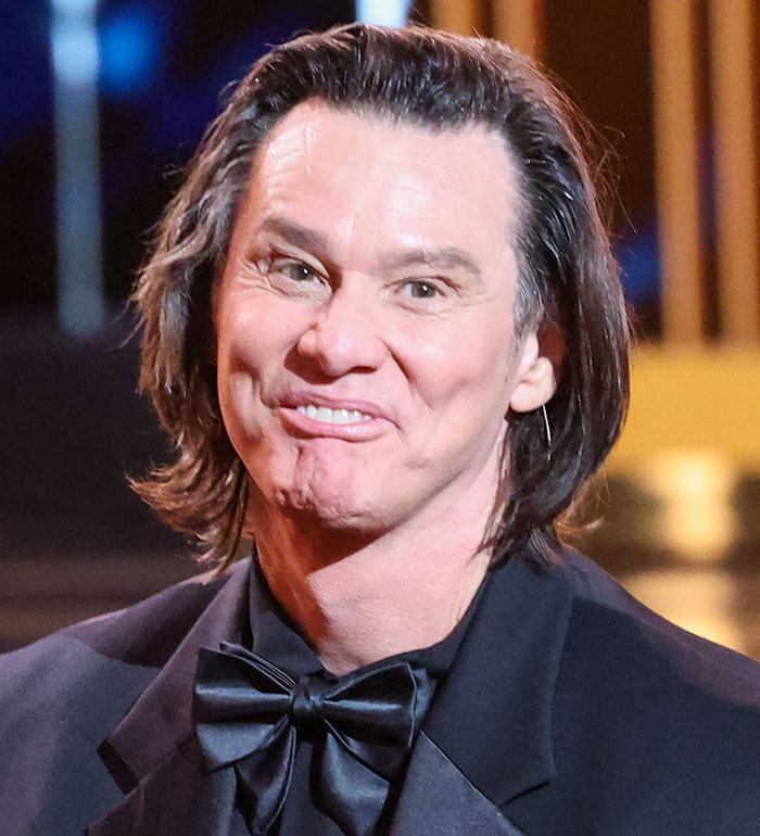 Jim Carrey wearing a black tuxedo with a bow tie, showing his new face and expressions revealing actor’s sadness.