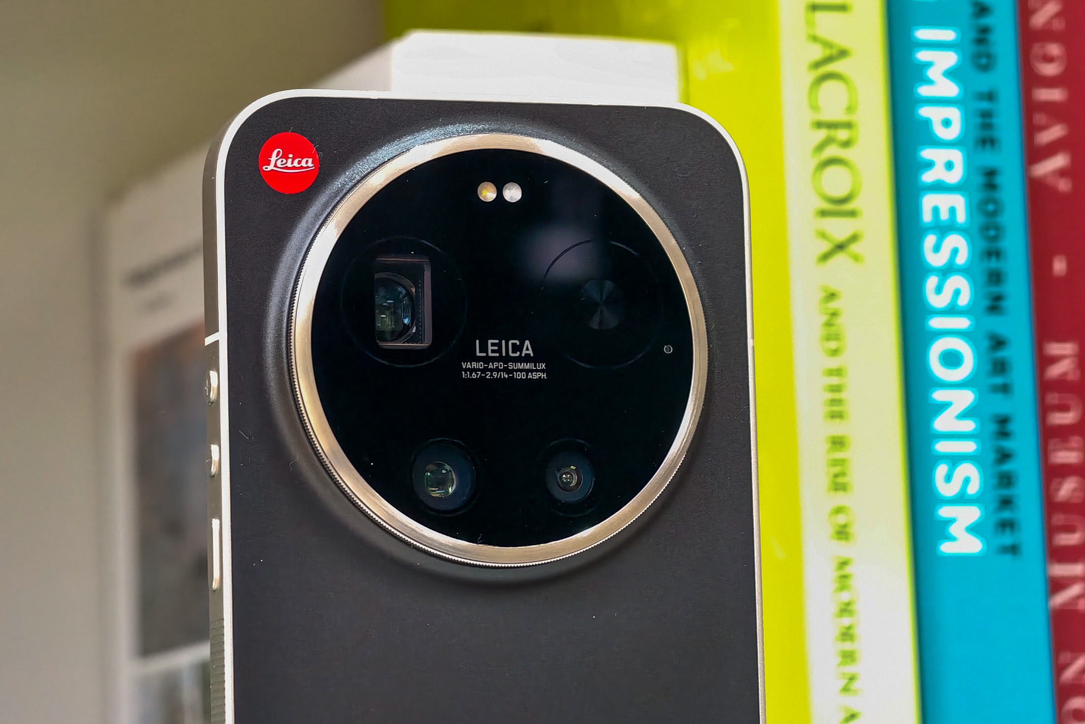 Photo of the Xiaomi Leica Leitzphone on a bookshelf, showing the camera