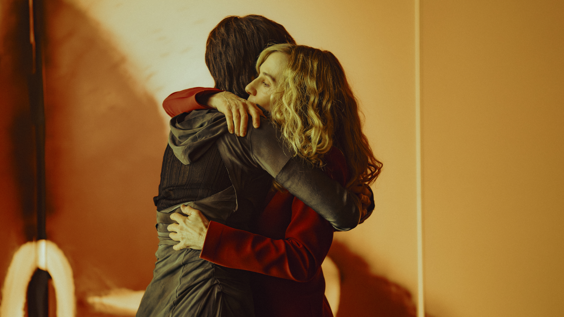 people in futuristic clothing in a brightly lit room